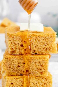 Bowl of plain yogurt next to cornmeal and baking ingredients for egg-free cornbread recipe